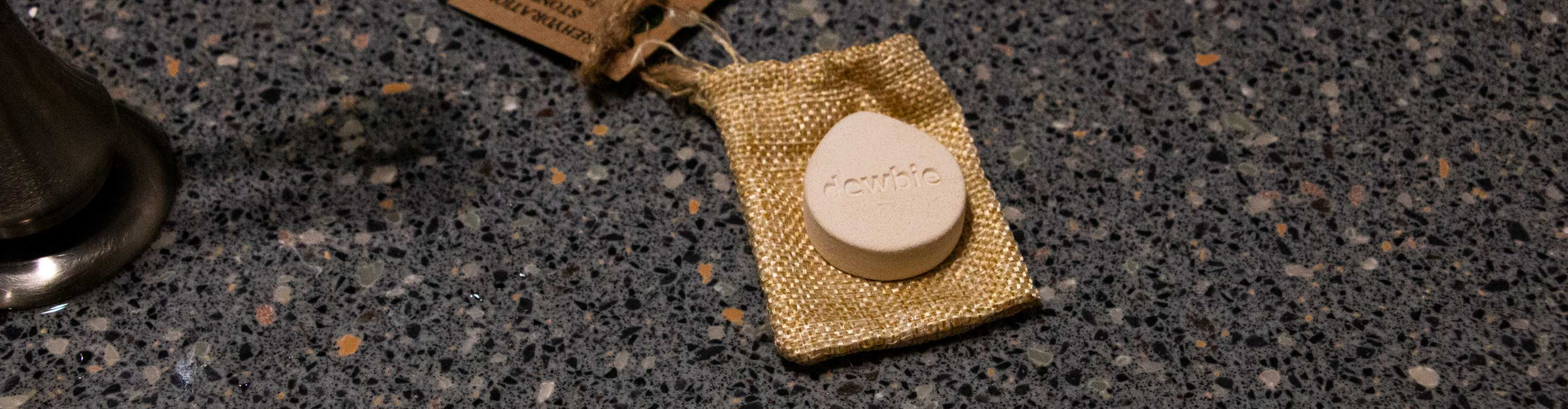 Dewbie Humidifier Stone laying down on bathroom sink.