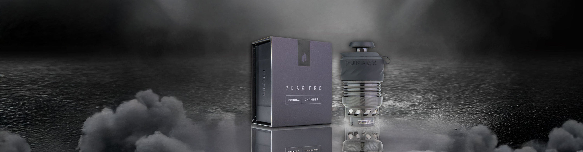 Puffco 3DXL Black Atomizer on reflective puddle with dark clouds nearby