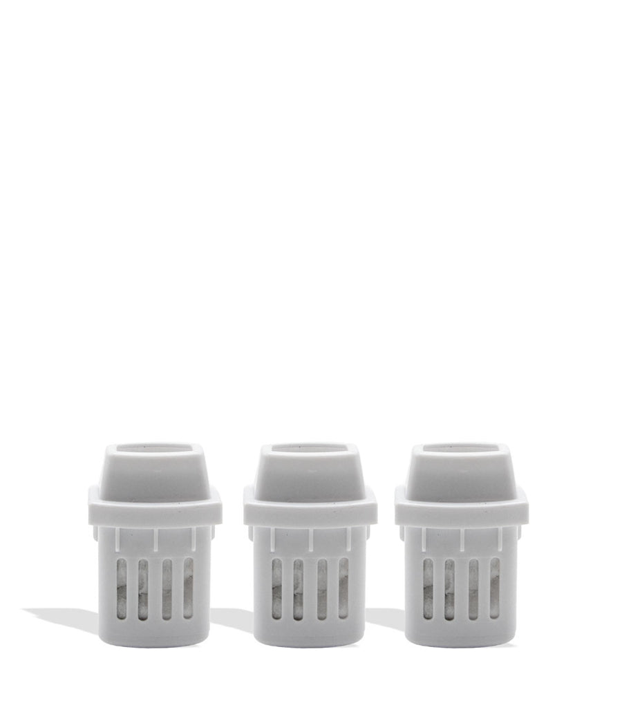 Three white plastic inhaler pieces on a white background